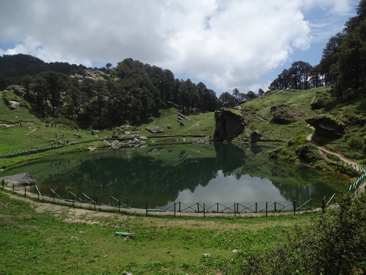 Serolsar Lake ringed by forest and green slopes