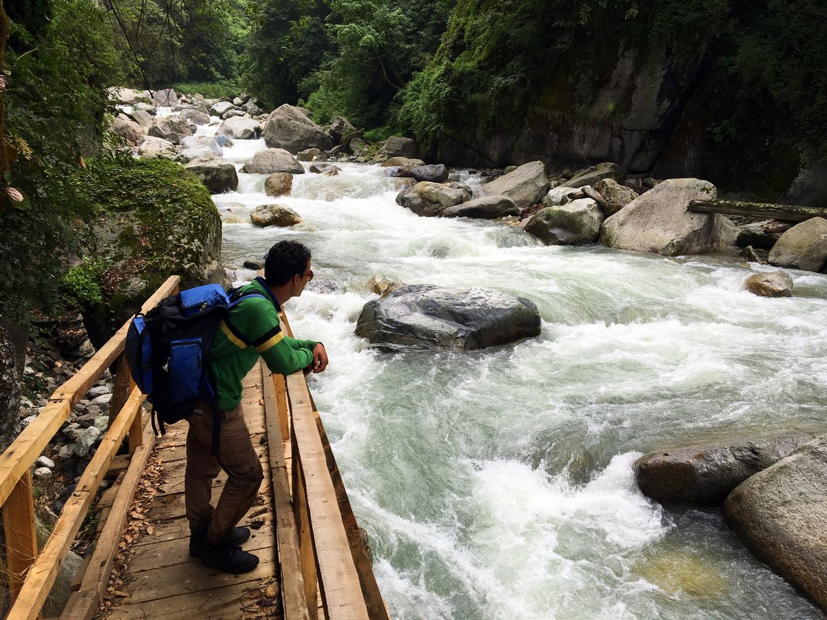 Clear water rushing over rocks in the Tirthan river