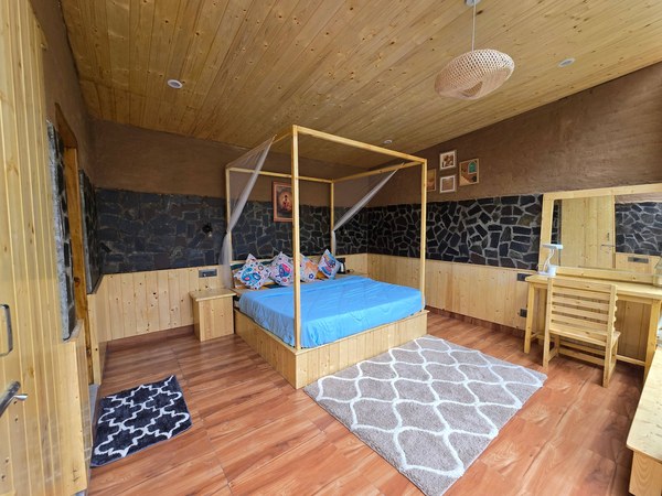 Four-poster bed and stone wall